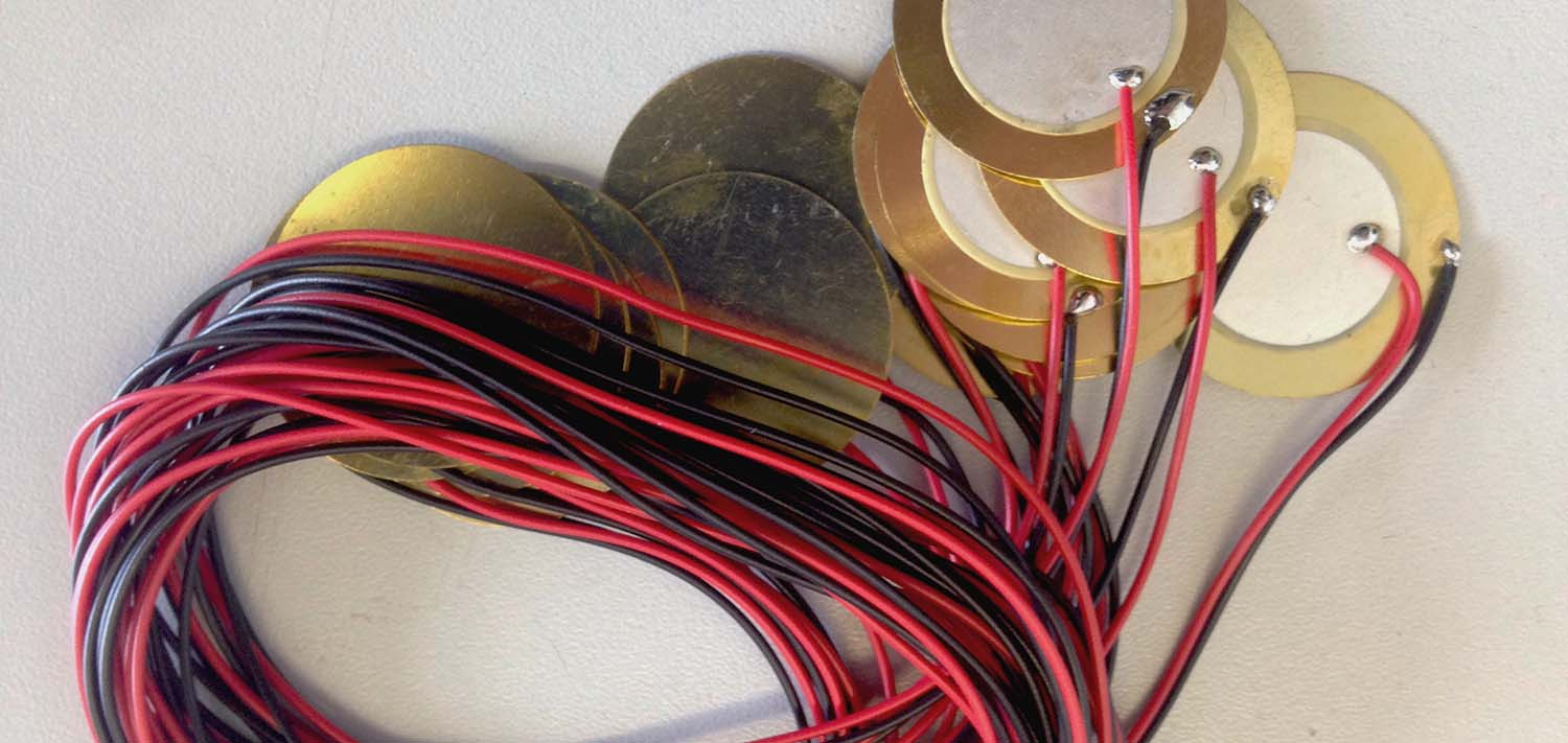 transducers rolled up - gold metal discs and red and blue wires