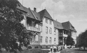 The Langenhagen’ Idioten Anstalt’ - a large white building with a group of people in front of it