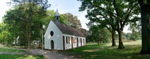 Langenhagen - a white chapel in a green space surrounded by trees