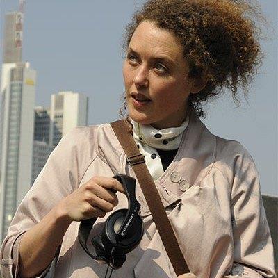 Profile image of Yolande Harris in a city holding headphones